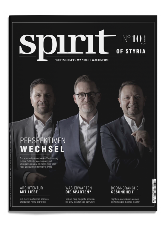 Drei Männer in Anzügen stehen nebeneinander auf dem Cover des Magazins "spirit of Styria", Ausgabe 10, vor einem schwarzen Hintergrund mit weißem Text.