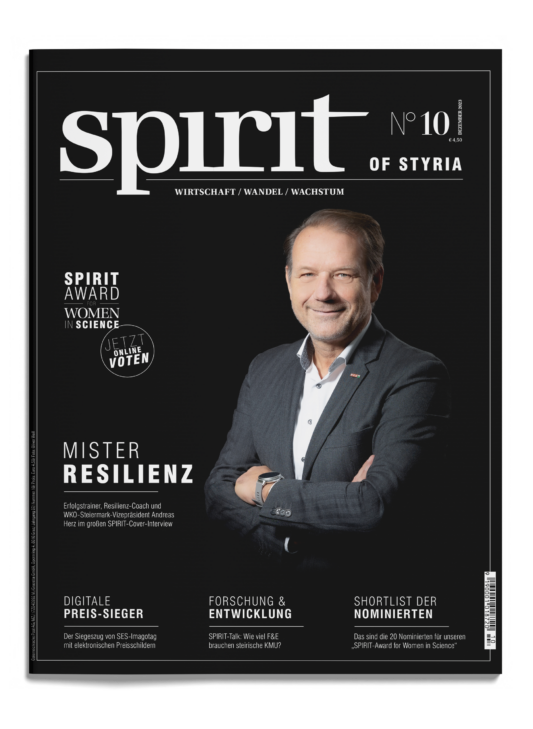 Das Titelbild einer Zeitschrift mit dem Titel "spirit of Styria" zeigt einen lächelnden Mann im Anzug mit verschränkten Armen und Schlagzeilen über Resilienz und Frauen in der Wissenschaft.