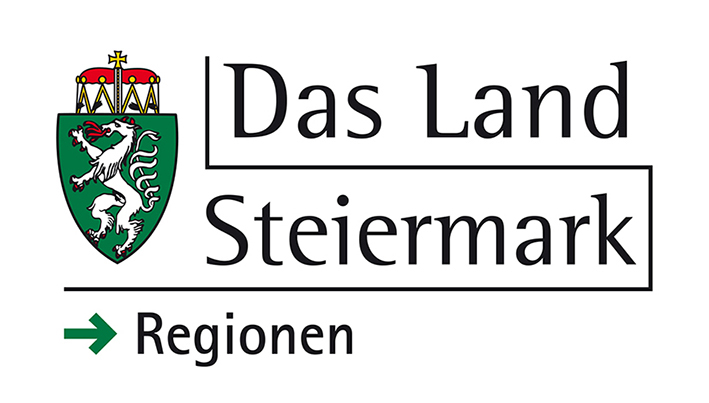 Logo der Steiermark, Österreich, mit einem gekrönten grünen Schild mit einem weißen, rotzüngigen Panther und dem Text "Das Land Steiermark → Regionen" in schwarzer Schrift auf weißem Hintergrund.
