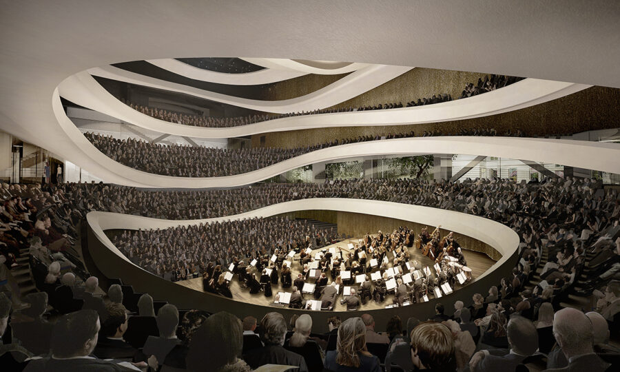 Ein moderner Konzertsaal mit mehreren geschwungenen Balkonen, die mit sitzenden Zuhörern gefüllt sind, die alle auf ein Orchester blicken, das auf einer zentralen Bühne spielt, umgeben von einer vielschichtigen, fließenden Architektur.