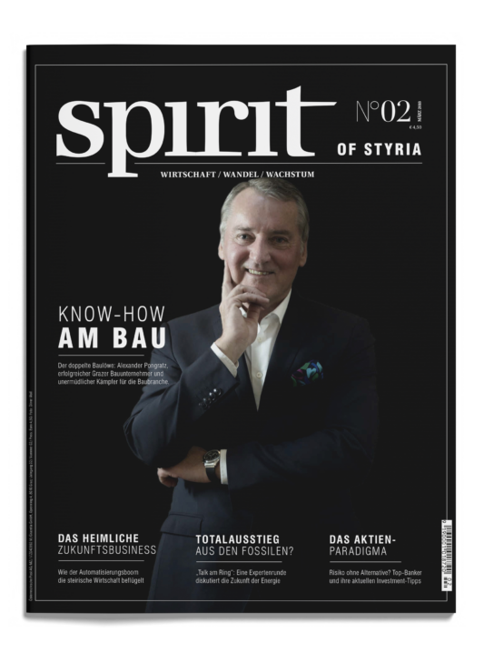 Ein lächelnder Mann im Anzug posiert mit der Hand am Kinn auf dem Cover des Magazins "spirit of styria", Ausgabe 2, mit deutschen Textüberschriften.