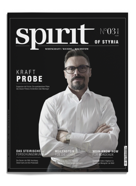 Ein selbstbewusster Mann mit Brille, Bart und weißem Hemd steht mit verschränkten Armen auf dem Cover des Magazins "spirit of styria", Ausgabe 03.