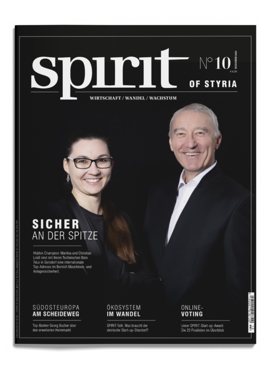 Ein Mann und eine Frau in Geschäftskleidung lächeln auf dem Cover des Magazins "Spirit of Styria", Ausgabe 10, mit deutschen Schlagzeilen über Führung und Wirtschaft.