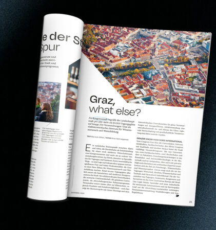 Ein aufgeschlagenes Magazin zeigt ein Luftbild von Graz, Österreich, über einem Artikel mit dem Titel "Graz, was sonst?" mit Text in Deutsch und Englisch.
