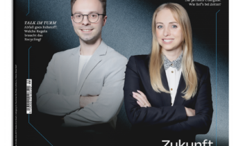 Ein Mann und eine Frau in Business-Kleidung stehen lächelnd auf dem Cover des Magazins "spirit of Styria", Ausgabe 03/26. Die Überschrift lautet "Zukunft im Schilde.